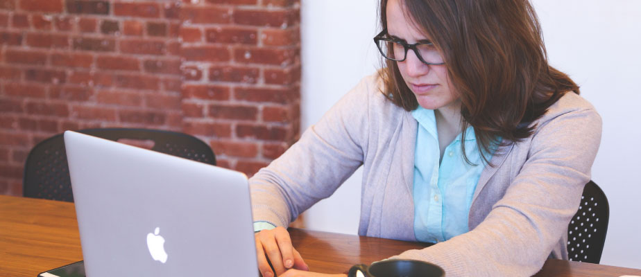 woman looking up information about root canal therapy on laptop