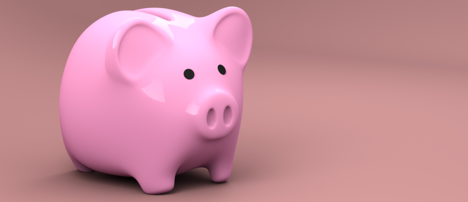 Pink plastic piggy bank for saving money against a darker pink background