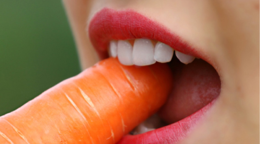 woman eating a carrot