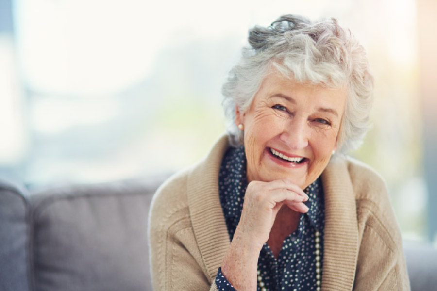 Smiling sweet faced older woman with dentures