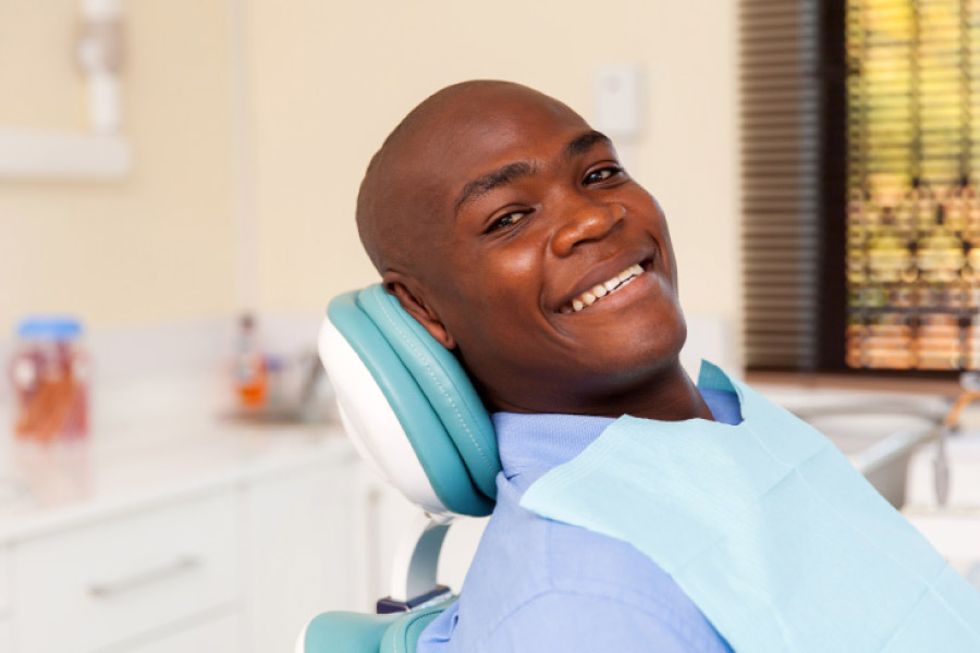 Smiling man in the dental chair.