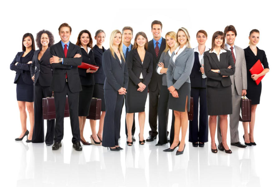 A group of men and women dressed in upscale office attire standing in a group.