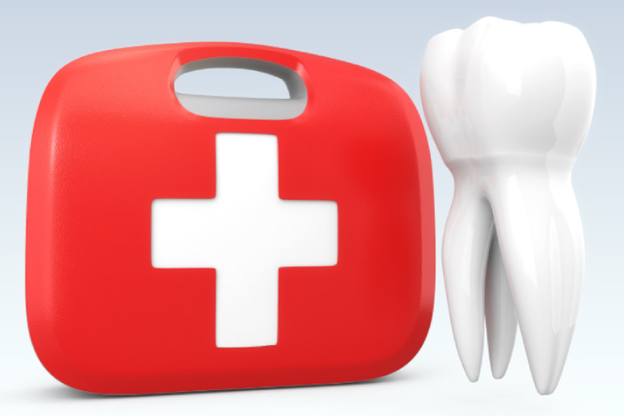 Red dental emergency kit next to a model of an oversized tooth.