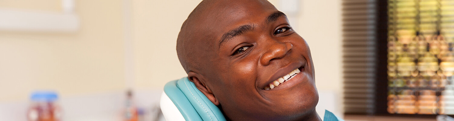 smiling man sitting in a dental chair