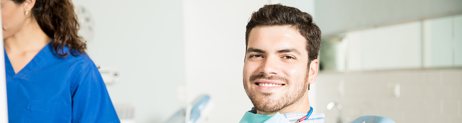 smiling man sitting in a dental chair