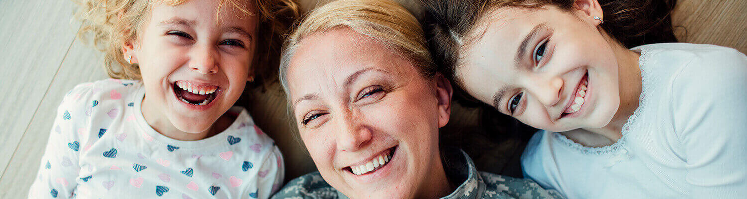 smiling mother and her two daughters