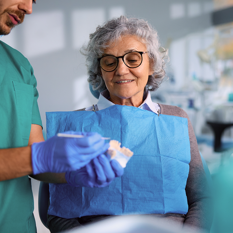 a dentist explaining bone grafting to patient