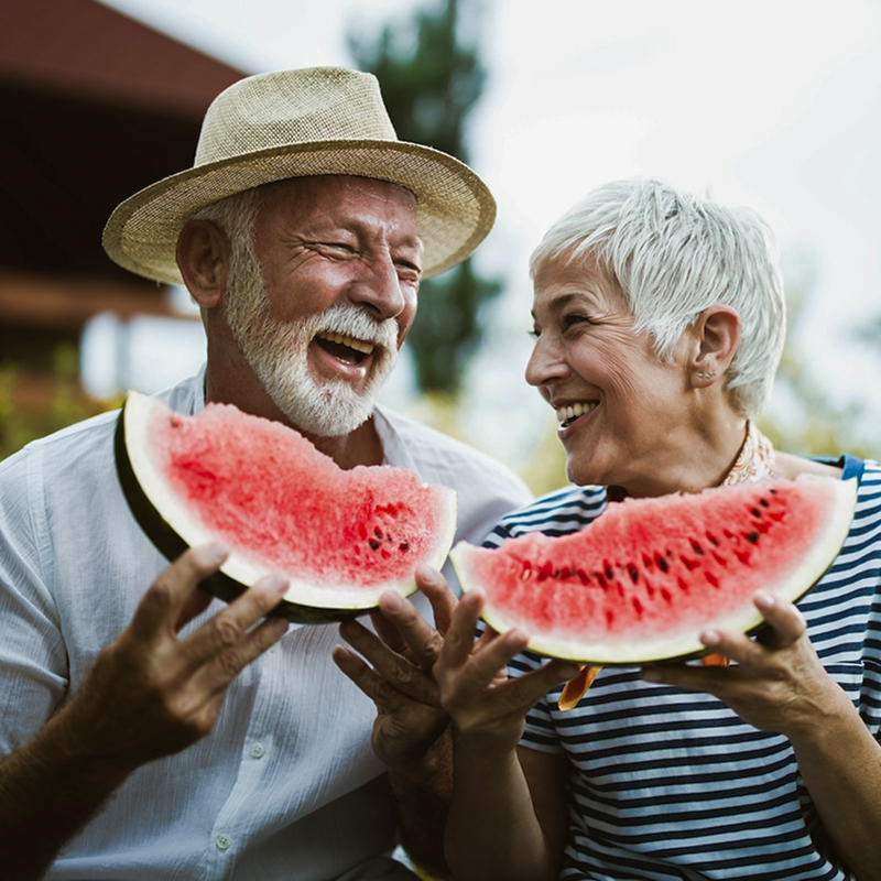 senior couple eating a watermelon