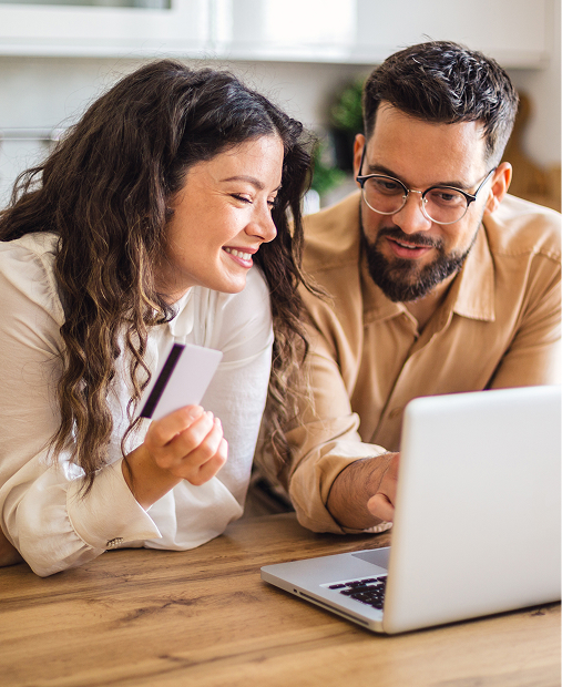 A happy couple paying bill
